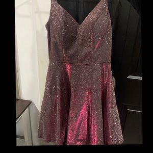 I am selling a glittery pink juniors dress mid length . Right above the knees .